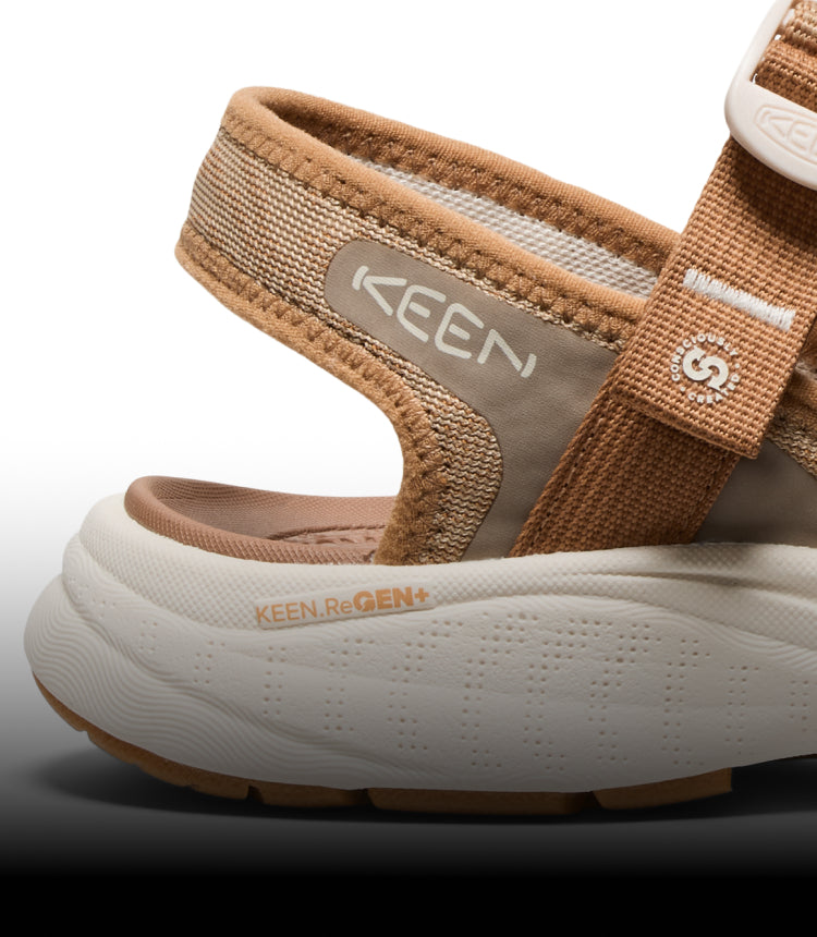 A close-up of the KEEN ReGEN sole on a beige and white KEEN sandal.