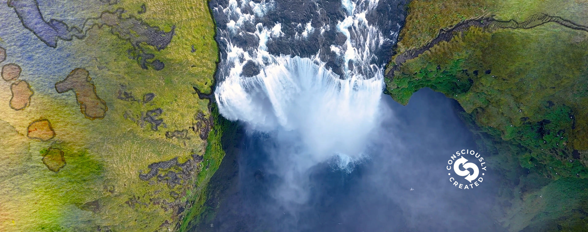 An aerial, top-down view of a massive, powerful waterfall cascading into a misty blue pool surrounded by green cliffs.