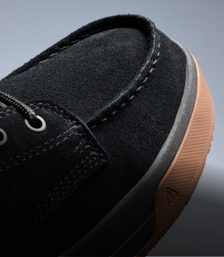 A close-up the toe of a black Gibson work boot.