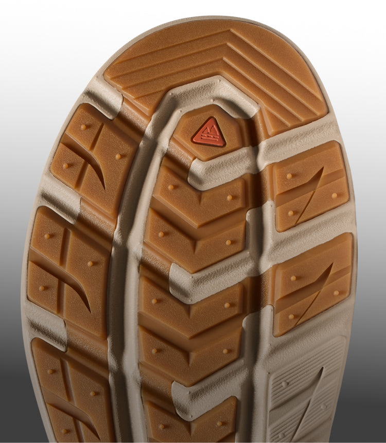 Close-up view of a KEEN shoe outsole featuring a rugged tan traction pattern and a small triangular orange logo.
