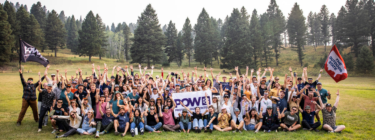 Protect Our Winters Team cheering in a field.
