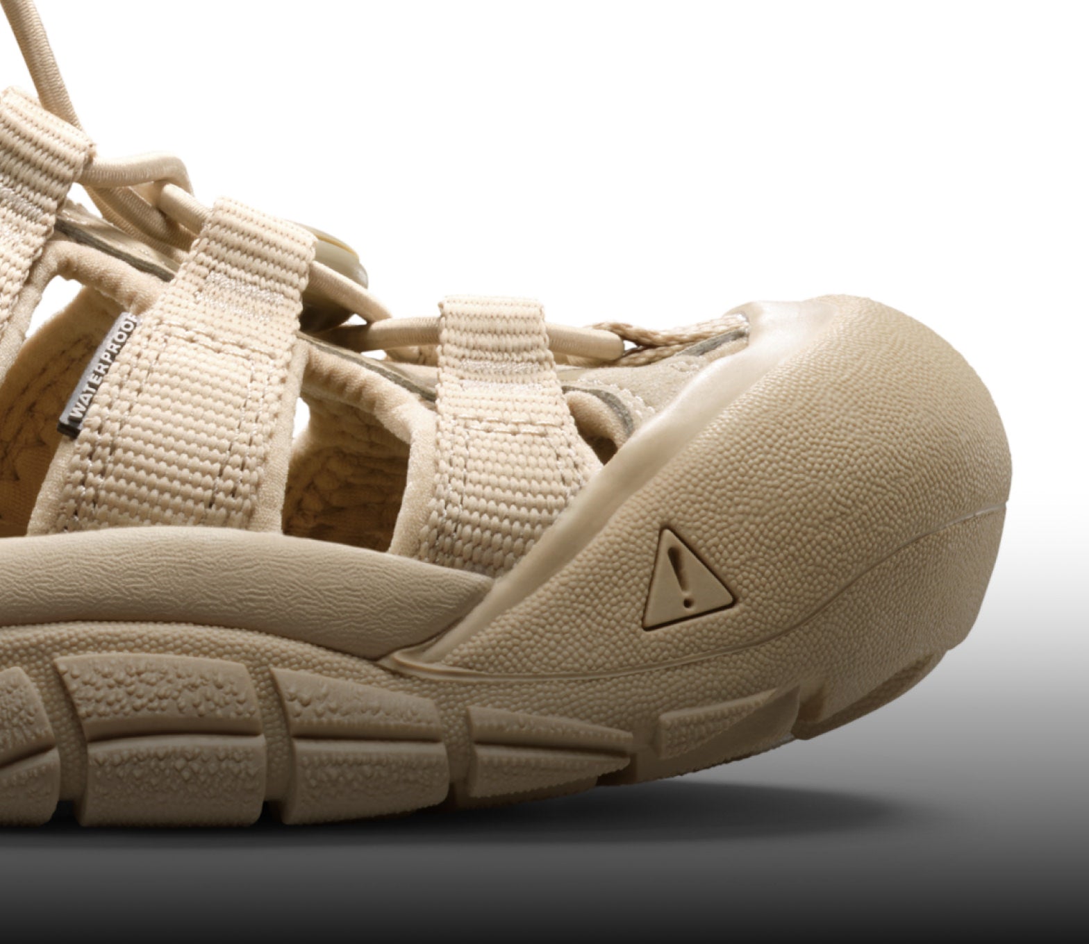 A close-up of a cream-colored Newport H2 sandal.
